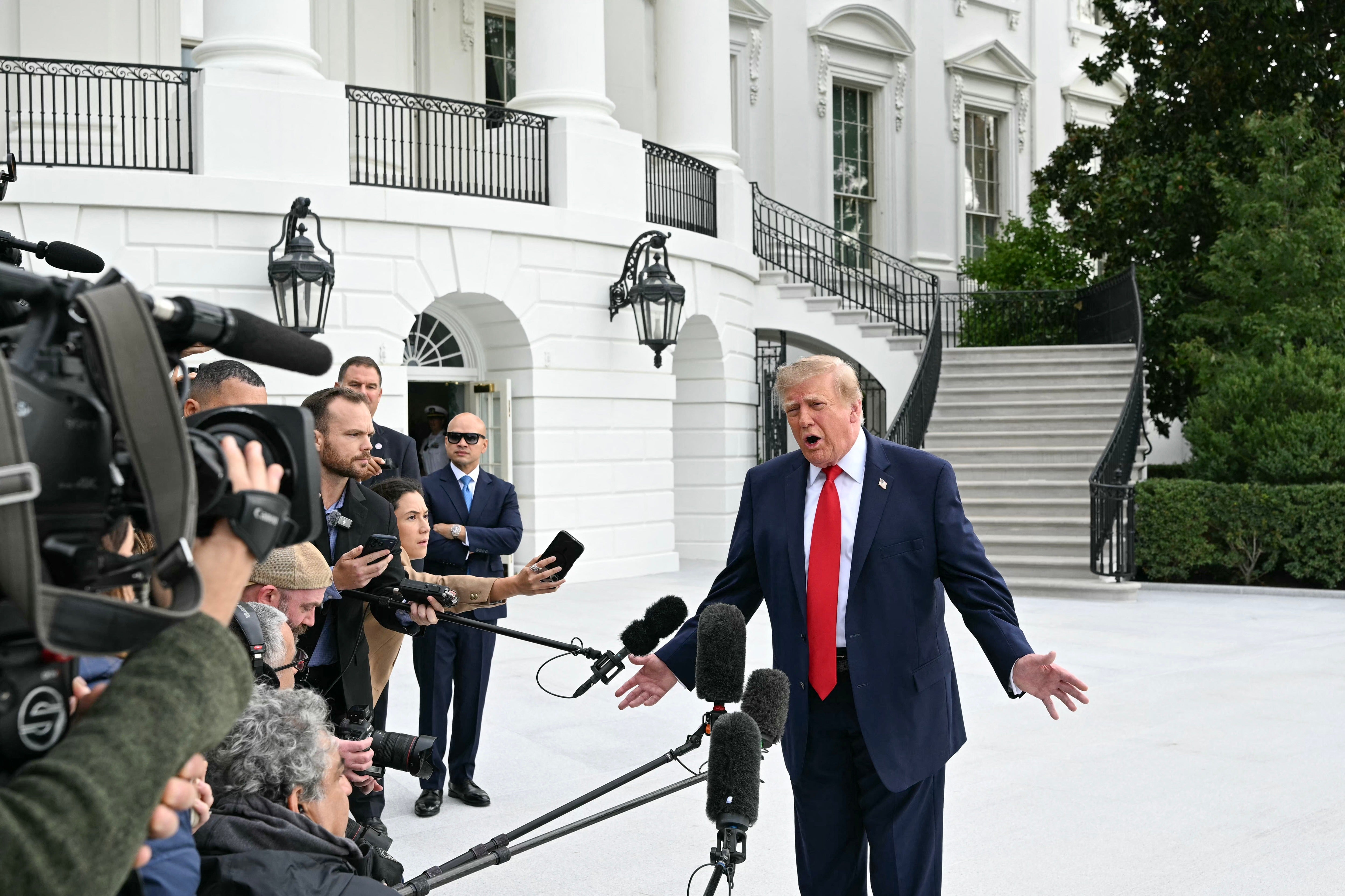 Trump speaks to members of the press before boarding Marine One as he departs from the South Lawn of the White House in Washington, DC, on September 26, 2026. US President Donald Trump is heading to Knoxville, Tennessee to attend the Tennessee/Texas college football game