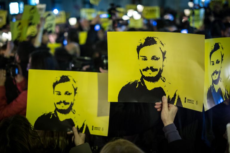 People during a 2018 march and torchlight procession in memory of the Italian researcher Giulio Regeni in Rome, Italy