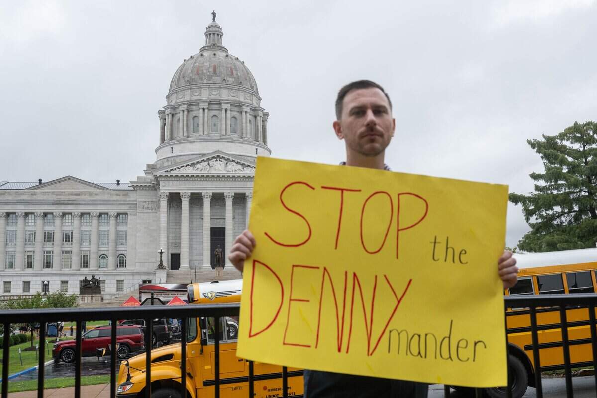 Keith Rose holds a sign in protest of Missouri Secretary of State Denny Hoskins on Thursday, September 10, 2026, in Jefferson City. Hoskins was called to the Supreme Court over whether he should be held in contempt for using a gerrymandered map that the court blocked.