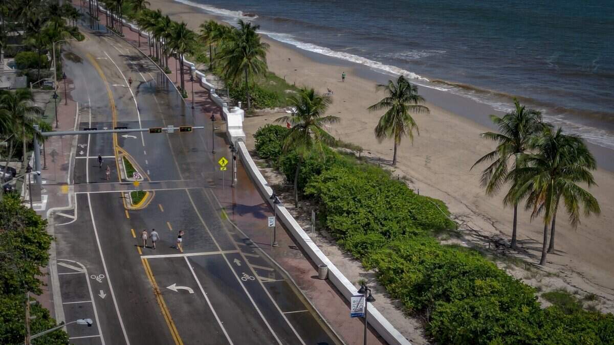 Sea level rise signs as king tides swamp coastal roads