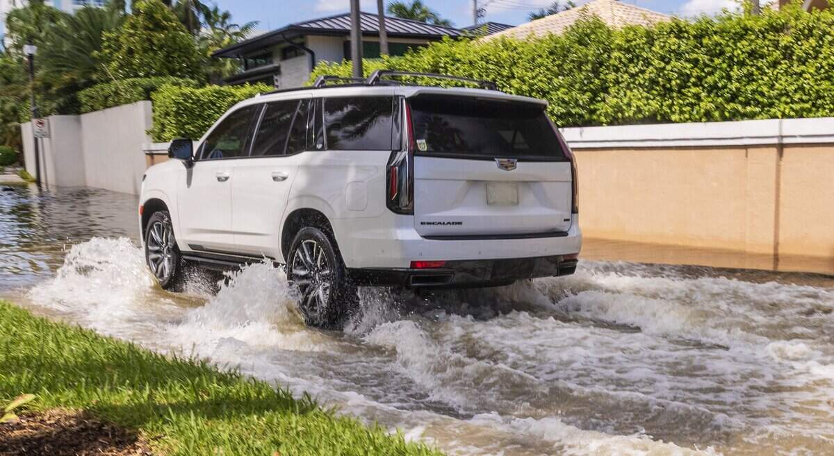 A car drives through a flooded street at A1A and Mayan Drive as a king tide led to sunny-day flooding on streets throughout South Florida, including Fort Lauderdale, on Sunday Sept. 27, 2026.