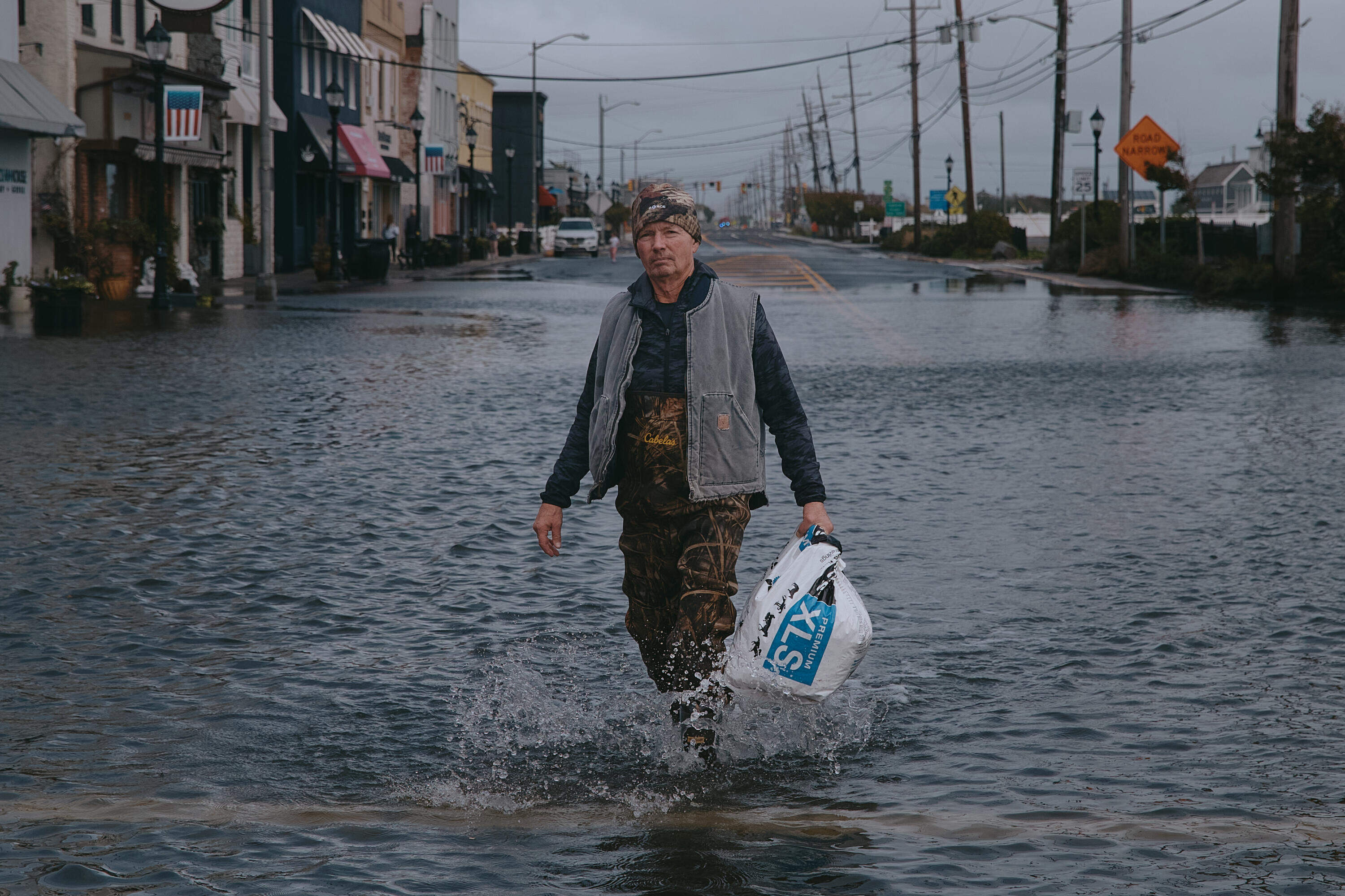 Bernard Dowd walks along a flooded street on Sunday, Sept. 27, 2026, in Sea Bright, N.J. (Andres Kudacki/AP)