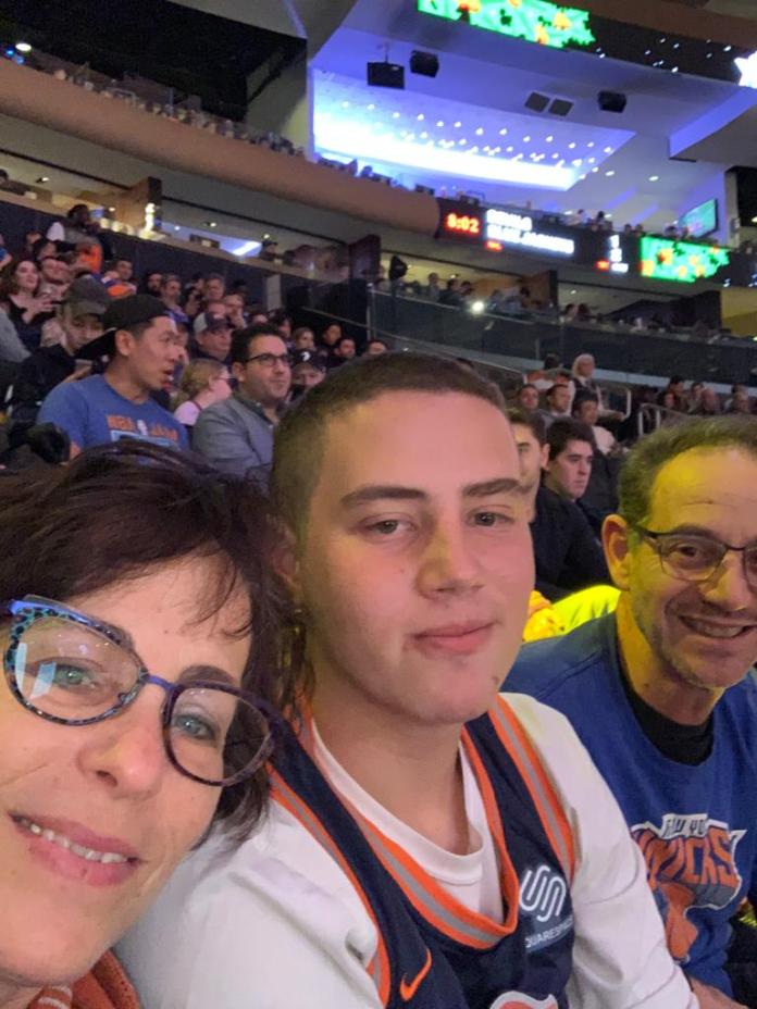 Omer Neutra, who is one of six Americans that has been held hostage by Hamas terrorist since Oct. 7, with his parents, Orna and Ronan, attending one of his beloved New York Knicks basketball games.