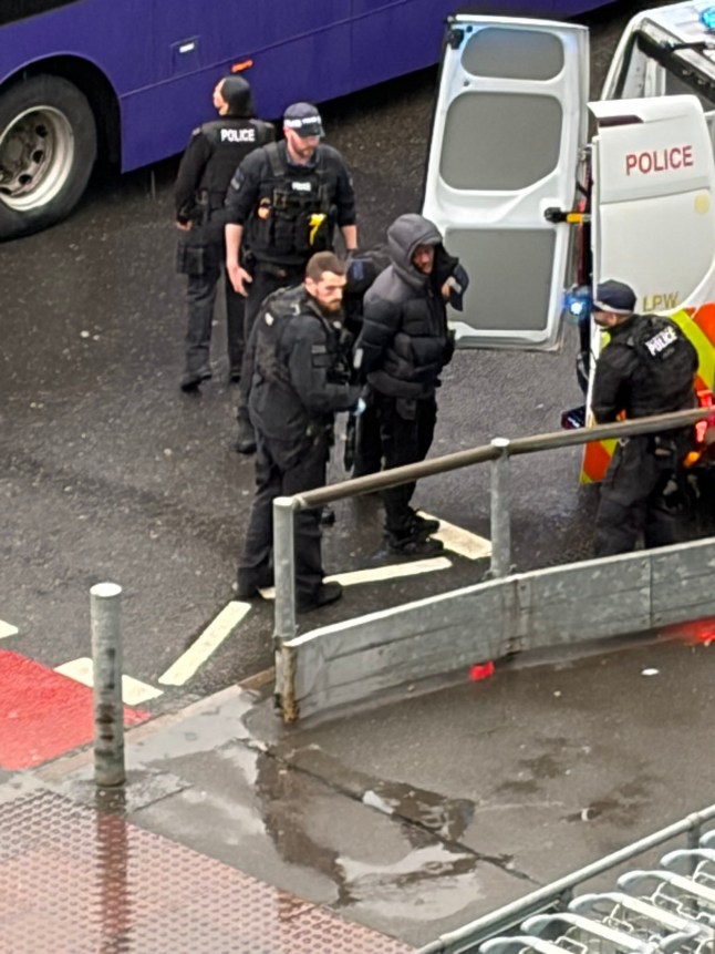 Handout photo taken with permission from the social media site X, formerly Twitter, posted by @_umarjaved of a person being detained by police officers outside Heathrow Terminal 3 after number of people were attacked with