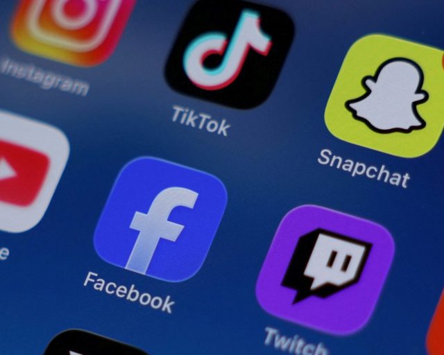 FILE PHOTO: Instagram, TikTok, Snapchat, YouTube, Facebook, Twitch and Reddit applications are displayed on a mobile phone ahead of new law banning social media for users under 16 in Australia, in this picture illustration taken on December 9, 2025. REUTERS/Hollie Adams/Illustration/File Photo