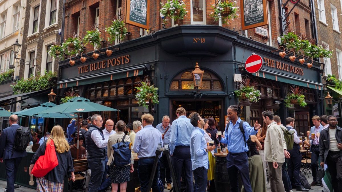 People drinking outside The Blue Posts pub on Kingly Street in the West End, Westminster, Soho, London, England, UK. (Photo by: Alex Segre/UCG/Universal Images Group via Getty Images)