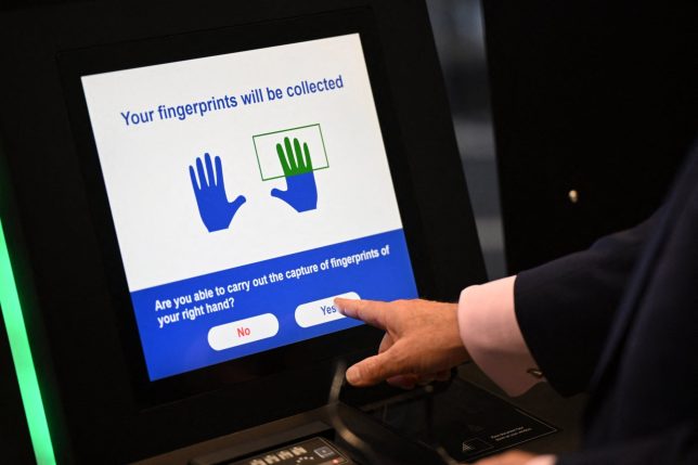 A person uses the Automated European Union Entry/Exit System (EES) kiosk during a press preview on the rollout of the EU's new Entry-Exit System (EES) at Eurotunnel, south east England on September 23, 2025. The European Union's new border-check system for non-EU nationals, the so-called Entry/Exit System (EES), which will do away with passport stamps, is set to finally launch October 12. (Photo by Justin TALLIS / AFP) (Photo by JUSTIN TALLIS/AFP via Getty Images)