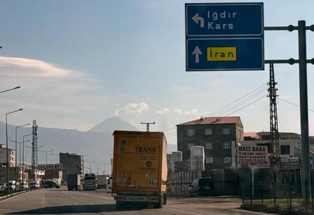 Trucks drive on the road leading to the Gurbulak border crossing on the Turkish-Iranian border.
