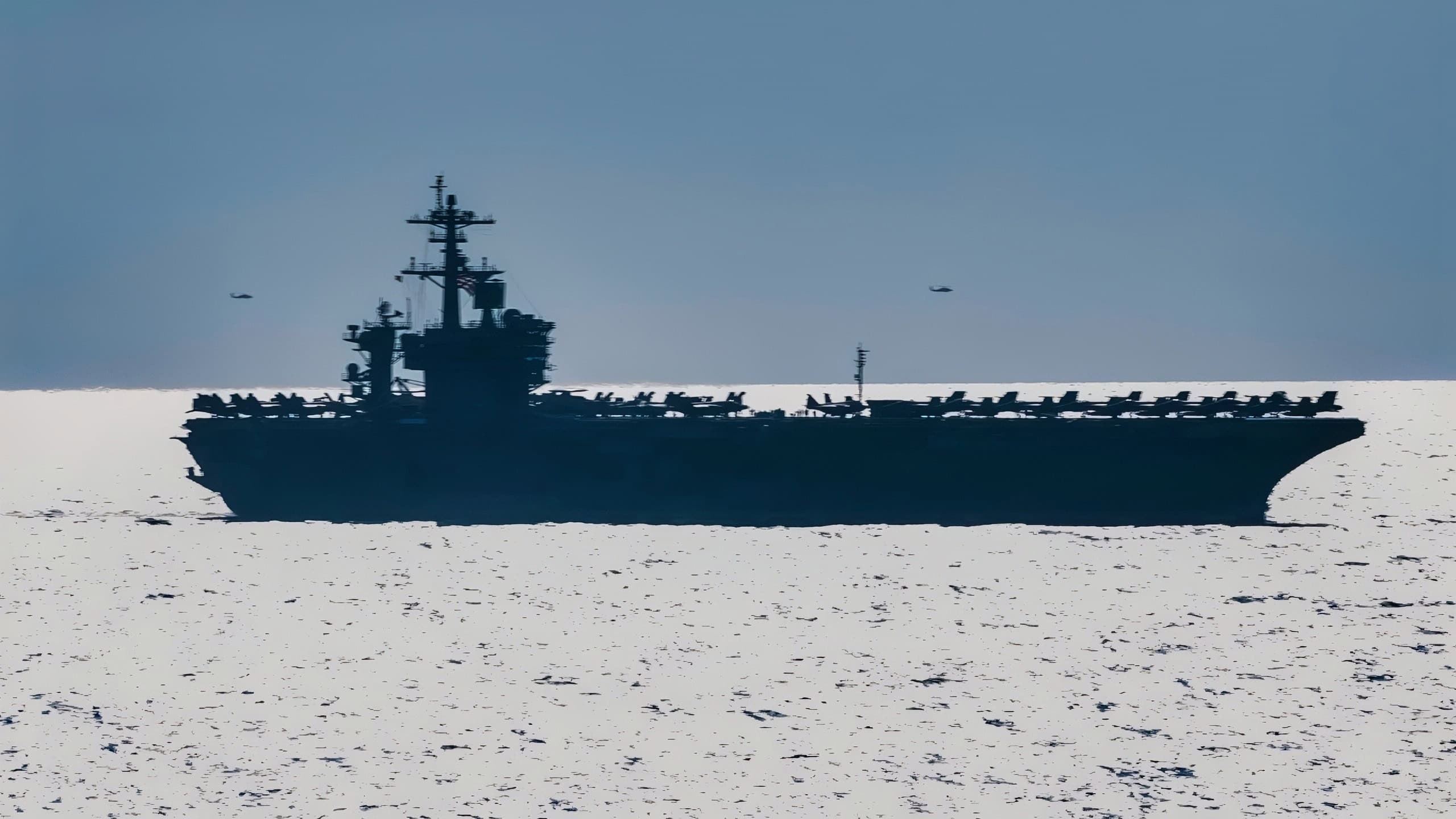 ATLANTIC OCEAN (Aug. 30, 2018) An MH-60S Sea Hawk helicopter assigned to Carrier Air Wing (CVW) 7 flies by the Nimitz-class aircraft carrier USS Abraham Lincoln (CVN 72) during dual-carrier sustainment operations with the Nimitz-class aircraft carrier USS Harry S. Truman (CVN 75). In addition to demonstrating the Navy's inherent flexibility and scalability, this evolution provides the opportunity to conduct complex, multi-unit training to enhance maritime interoperability and combat readiness; prepare the Navy to protect our homeland; and preserve and promote peace anywhere around the world. (U.S. Navy photo by Mass Communication Specialist 3rd Class Juan Sotolongo/Released)
