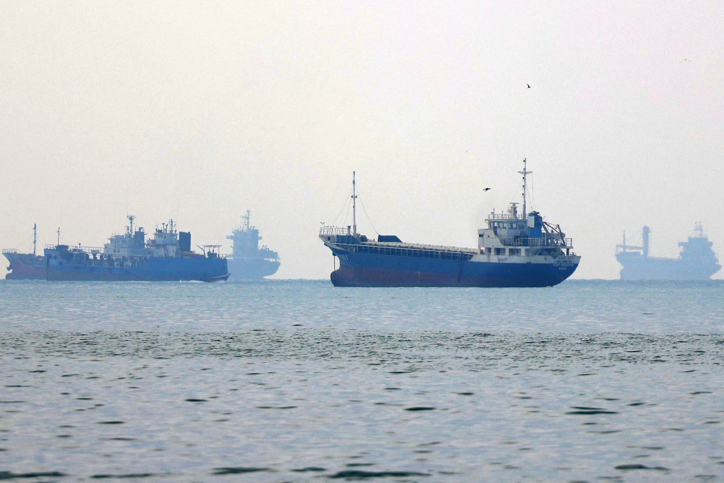 Vessels transit the Hormuz Strait off the coast of Iran's southern port city of Bandar Abbas on Monday.