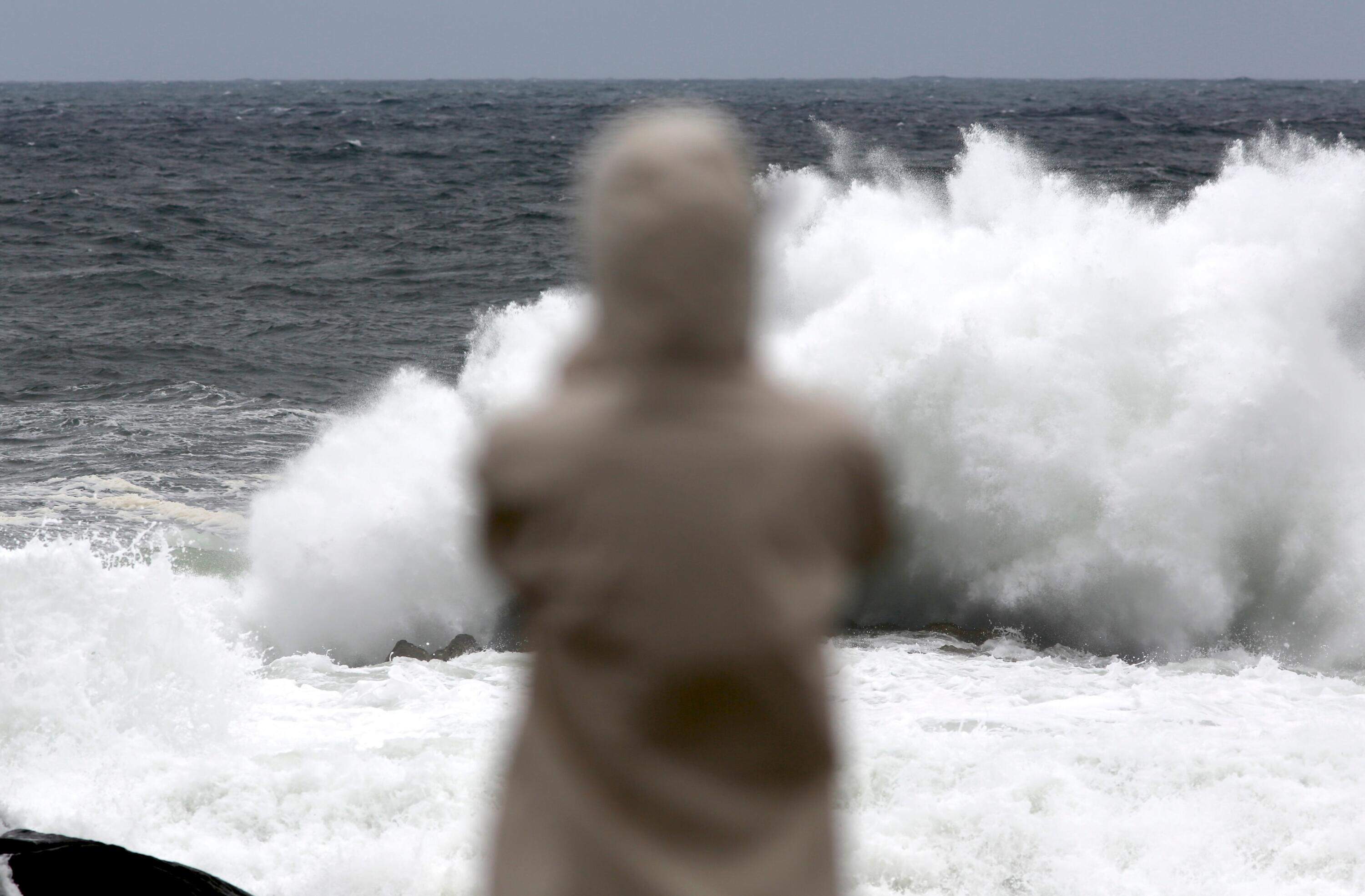 A person watches as waves crash during a nor'easter in York, Maine, Saturday, Sept. 26, 2026. (Caleb Jones/AP)
