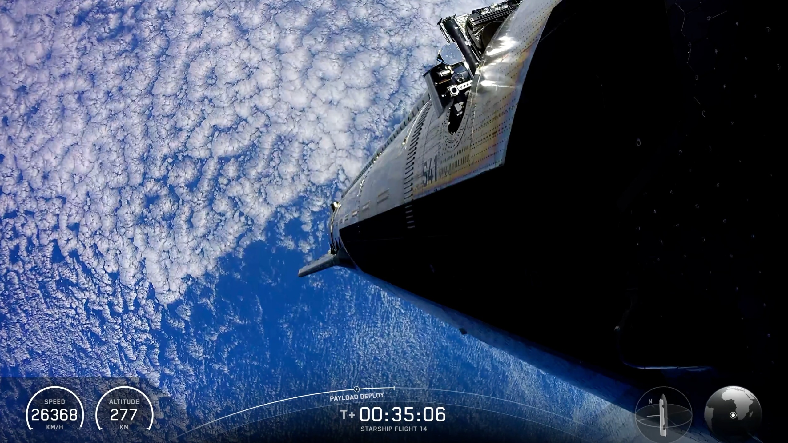 view from a large silver spacecraft looking down at its body and earth below