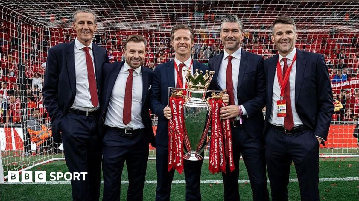 Barry Hunter, Julian Ward, Michael Edwards, Richard Hughes and David Woodfine pose for a photograph with the Premier League trophy at the end of the 2024-25 season.