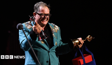 Alan Carr accepts the 'Special Recognition' award on stage during the National Television Awards 2026 show at The O2 Arena.