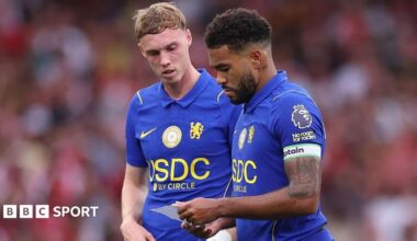 Reece James and Cole Palmer reading a note in the second half against Arsenal