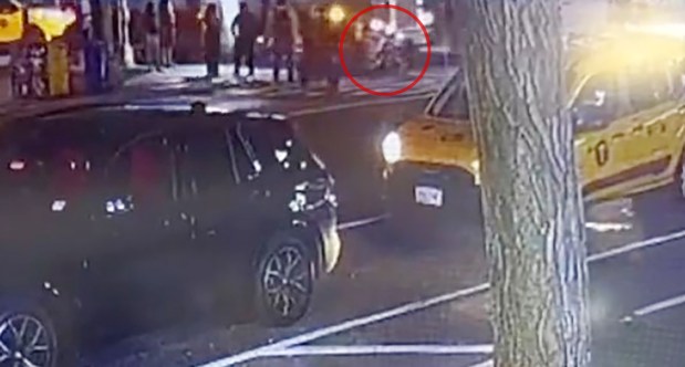 Video footage obtained by the Daily News shows the two girls riding on a Citi Bike moments before being struck by the truck pictured behind them. (Obtained by Daily News)