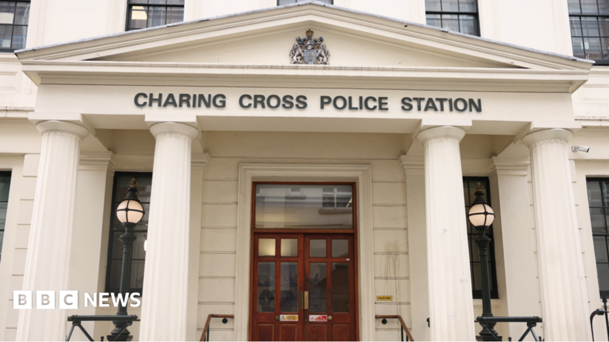The front of Charing Cross police station, with the name of the station visible above the door on a Roman style entrance