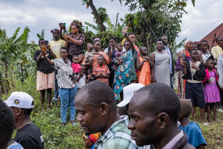 TOPSHOT - Members of the public react as the body of the late King Oyo Nyimba Kabamba Iguru Rukidi IV makes its way to Karambi Royal Tombs for burial in Fort Portal, Uganda, on September 12, 2026.