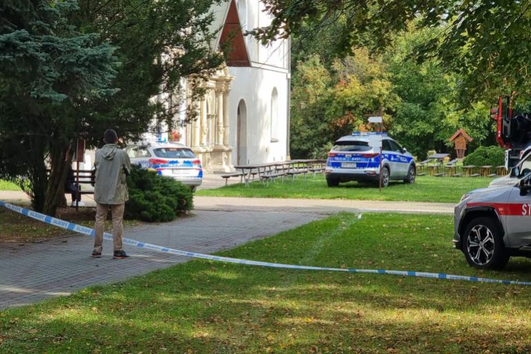 In this handout photograph taken and released by Gazeta Jaroslawska on September 24, 2026, a man stands behind police tape at the site of a knife attack in Jaroslaw, eastern Poland.