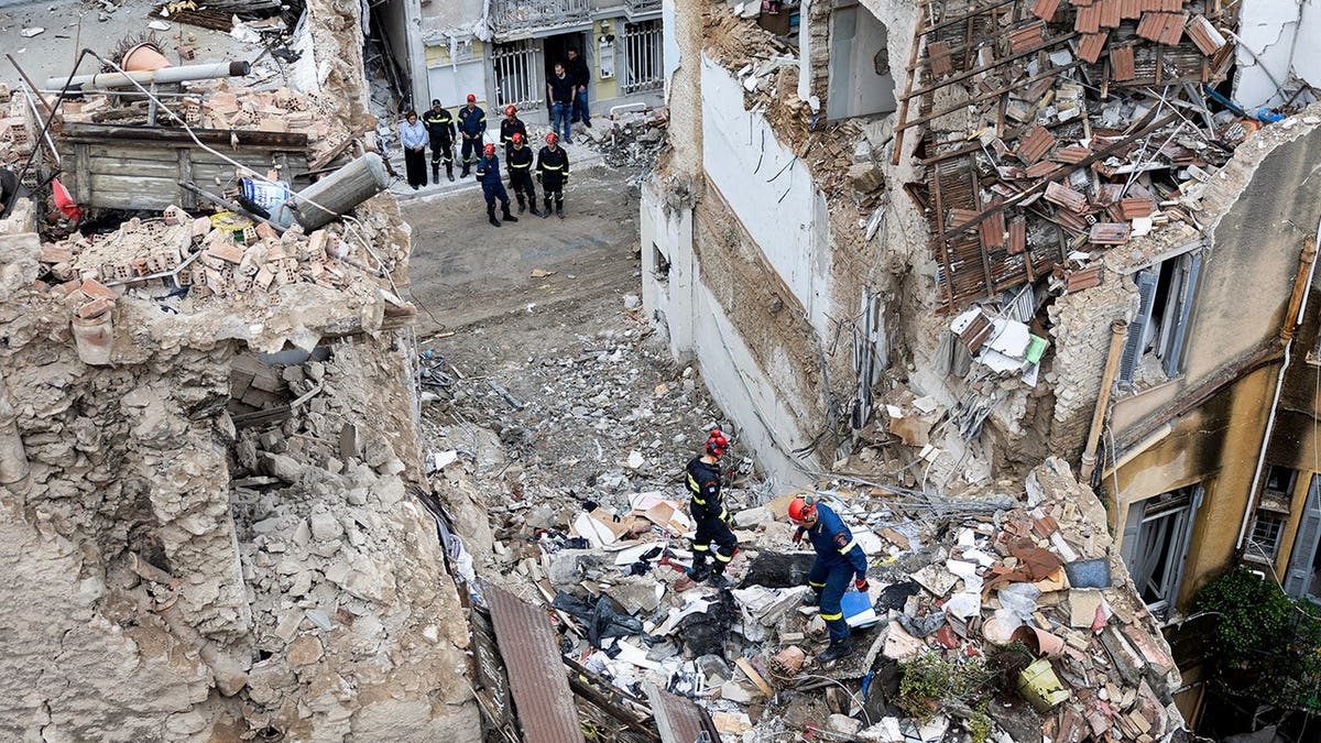 Firefighters work at the scene following a blast in Athens' Plaka district.
