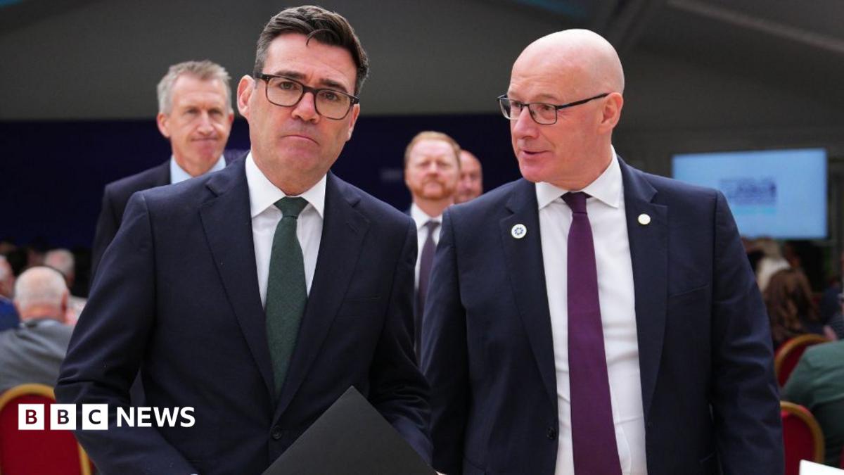 Two men in business suits walk side by side