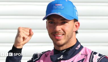 Alpine's Pierre Gasly poses with a picture of the '1' board after taking pole position at the Italian Grand Prix