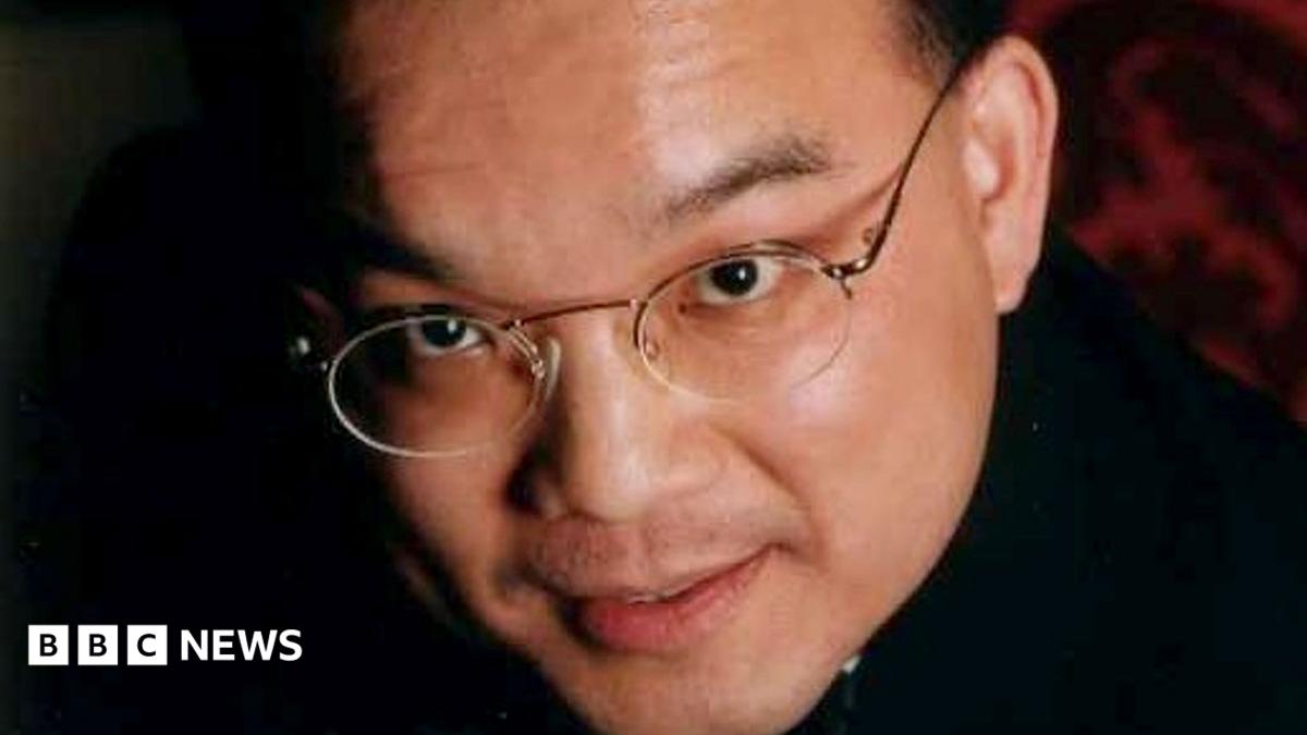 Close up image of Kenneth Law's face. He is looking at the camera and is wearing glasses.