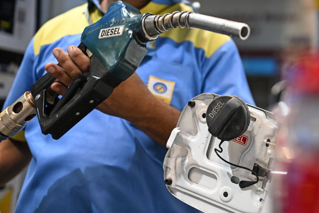 An attendant refuels a vehicle at a Bharat Petroleum petrol station in New Delhi last month. India imports most of its oil and gas. Photo: AFP