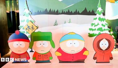 Characters from South Park TV show as cut-outs on a stage with a wintery backdrop.