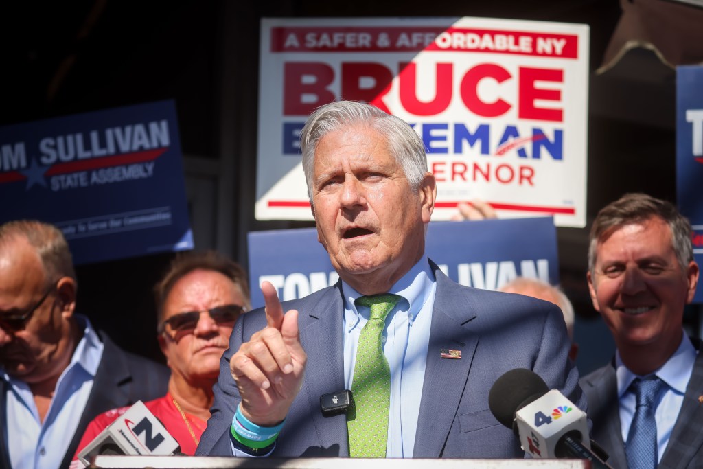 Bruce Blakeman, New York Republican gubernatorial candidate, speaking at a campaign event with campaign signs visible behind him.