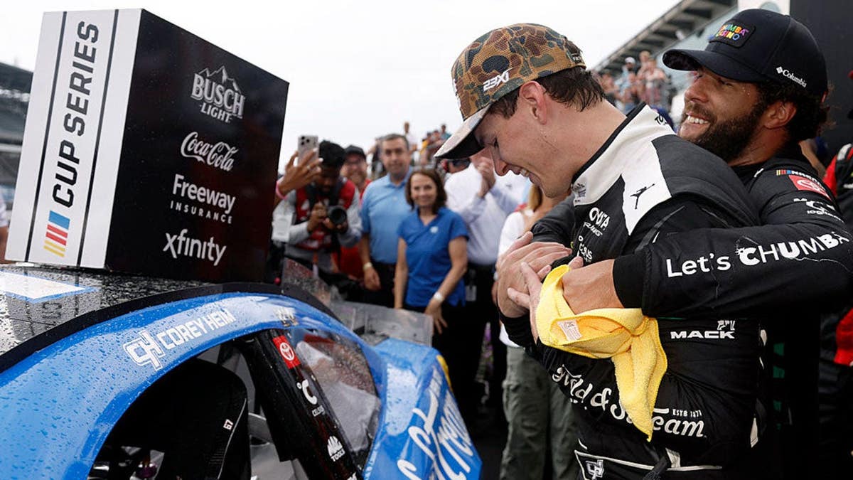 Bubba Wallace hugs Corey Heim in victory lane after the Brickyard 400.
