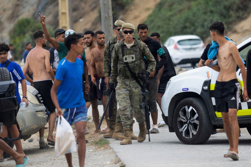 Spanish soldiers patrol by Trampolin Beach, following recent mass crossings of migrants from Morocco to Ceuta, in Ceuta, Spain, on Sunday.
