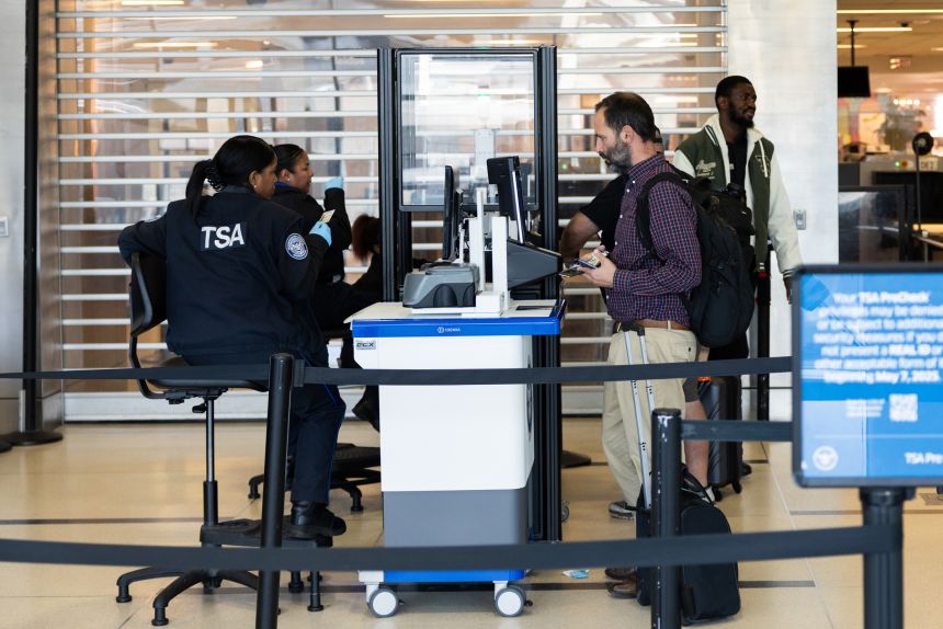 Transportation Security Administration document checkers examine IDs at Philadelphia International Airport on Friday, Oct. 24, 2025.