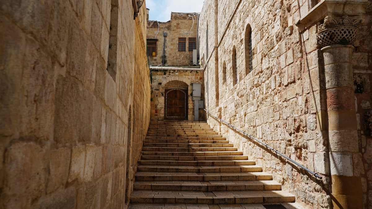 A locked door and empty stairs leading to the Church of the Holy Sepulchre in Jerusalem's Old City, closed to visitors amid heightened security during the war with Iran, Friday, March 27, 2026.