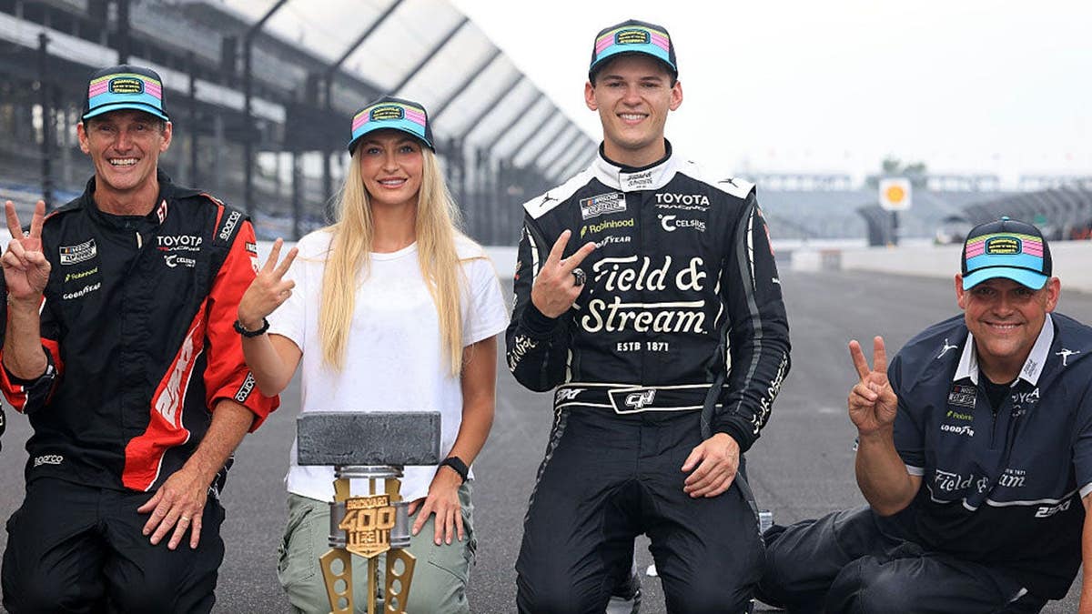 Corey Heim, Taylor Reimer and Robert Barker pose at Indianapolis Motor Speedway.
