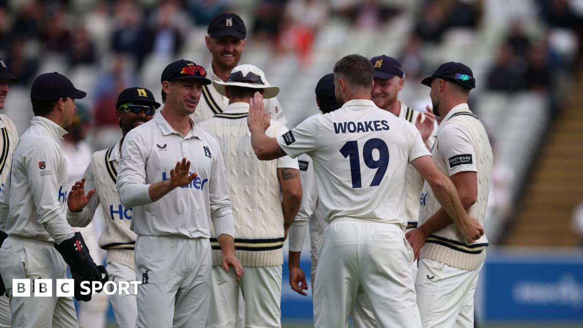 Warwickshire's players, led by former England all-rounder Chris Woakes, celebrate taking a wicket