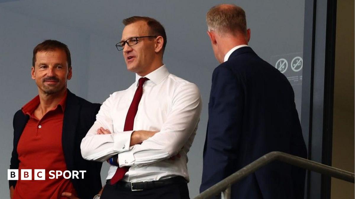 Daniel Kretinsky (centre) with is arms crossed