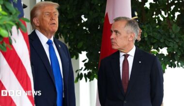 US President Donald Trump speaks to Canadian Prime Minister Mark Carney  during a welcome outside the West Wing of the White House in October 2025