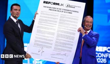 Reform UK leader Nigel Farage and National Rally President Jordan Bardella hold a large version of the proposed agreement
