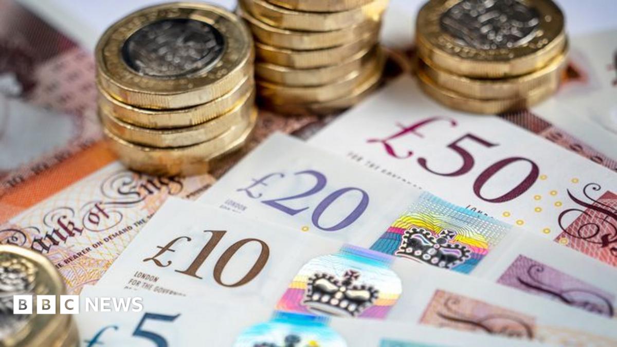 One pound coins stacked on top of notes.