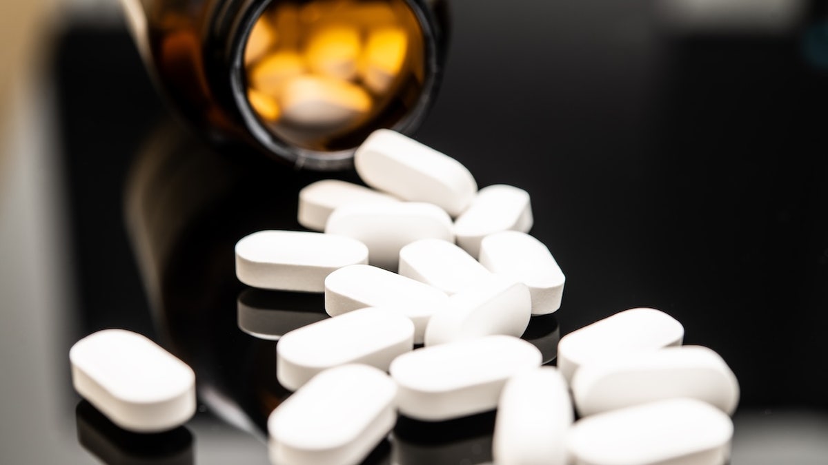 Pills spilling out of prescription bottle