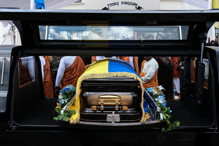 FORT PORTAL, UGANDA - SEPTEMBER 12: A casket containing the body of the Late Oyo Nyimba Kabamba Iguru Rukidi IV is loaded on a cortege after leaving the Karuziika Royal Palace ahead of the burial at the Karambi Royal Tombs on September 12, 2026 in Fort Portal, Uganda. An official burial is taking place for Oyo Nyimba Kabamba Iguru Rukidi IV, a traditional Ugandan ruler of the Tooro kingdom, who died aged 34 on August 27, 2026, while being treated for a critical illness in the United States. In the wake of the king's death, a dispute has broken out between the monarch's family and the succession committee over who should succeed him. (Photo by Hajarah Nalwadda/Getty Images)