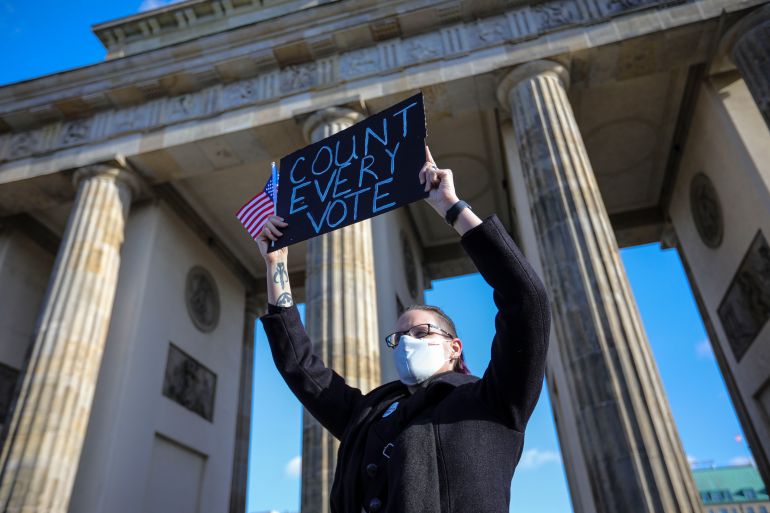 A protester holds a banner reading ‘Count every vote’ as supporters of Democrats Abroad rally near the US Embassy in Berlin, Germany, on November 4, 2020,