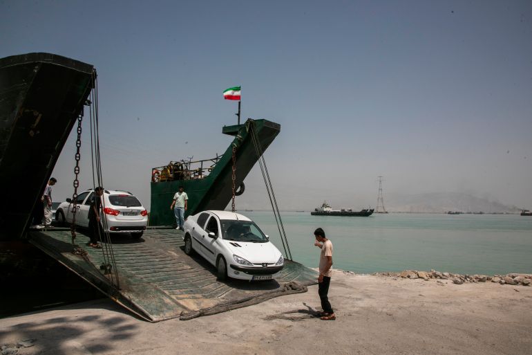 STRAIT OF HORMUZ, IRAN - MAY 16: Cars leave a ferry as ships remain anchored on May 16, 2026 in the Strait of Hormuz near Larak Island, Iran. Negotiations between the U.S. and Iran over opening this critical waterway have largely stalled as the countries have rejected each other's proposals to end the war that began when the U.S. and Israel attacked Iran on February 28. (Photo by Majid Saeedi/Getty Images)