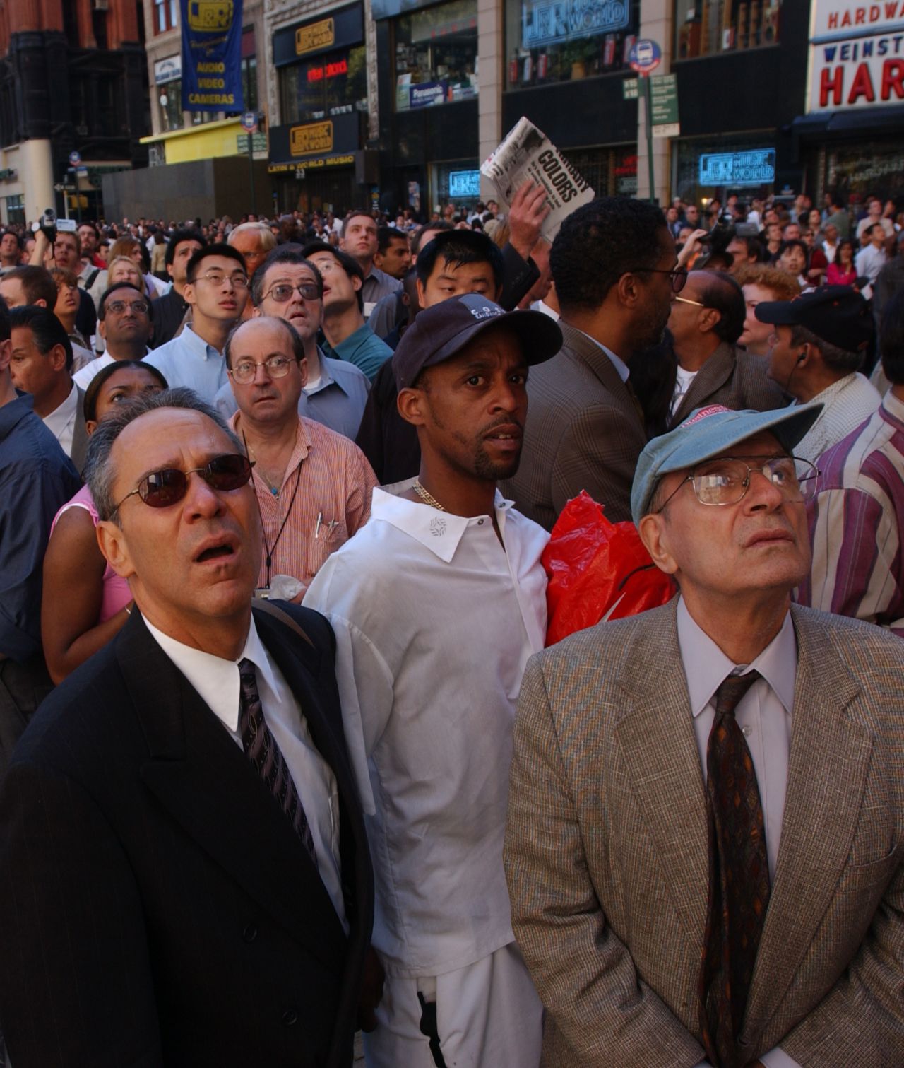 People watch smoke rise from the World Trade Center on September 11, 2001.