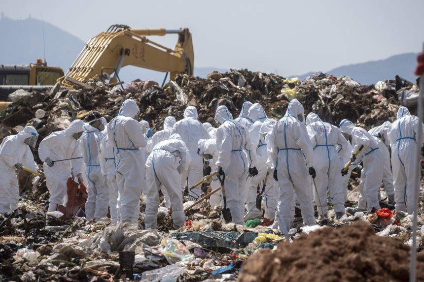 Police officers dress in PPEs searching a part of the Landfill for Evidence in a murder case in Hong Kong, on February 28, 2023.