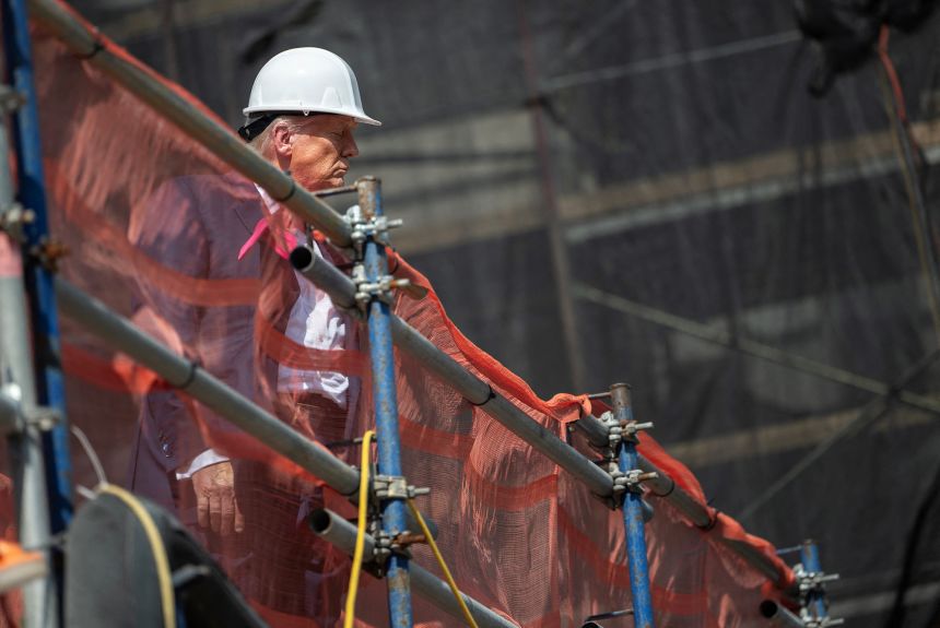 President Donald Trump looks over the construction site as he visits the Federal Reserve in Washington, DC, on July 24, 2025.