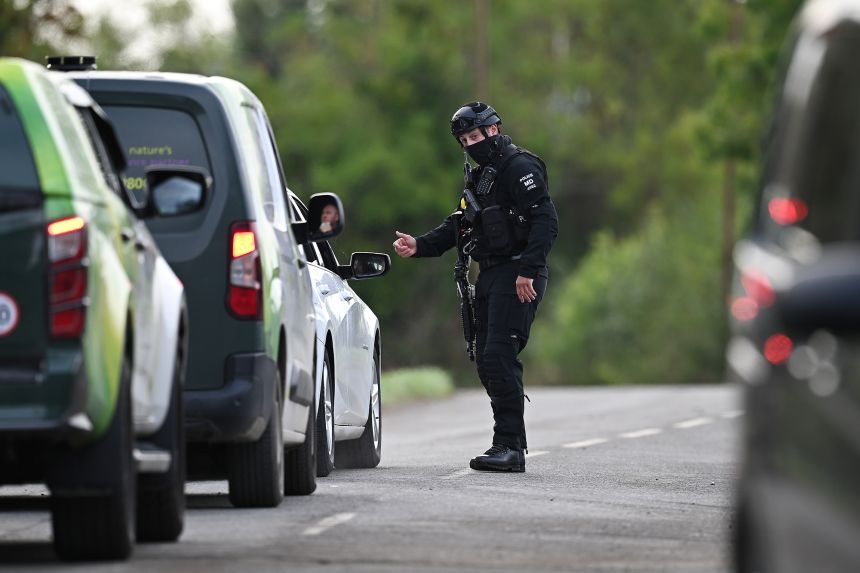 Armed police maintain road blocks and security checks around RAF Fairford on Monday.