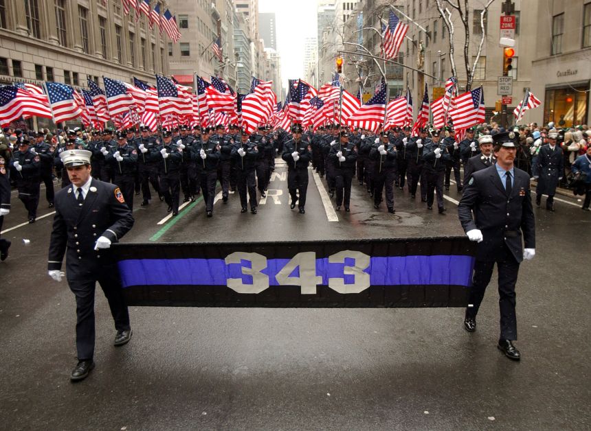 New York City Fire Department firefighters march up 5th Avenue in the St. Patrick's Day Parade carrying a banner signifying 343, the number representing the FDNY firefighters killed in the attacks on the World Trade Center.