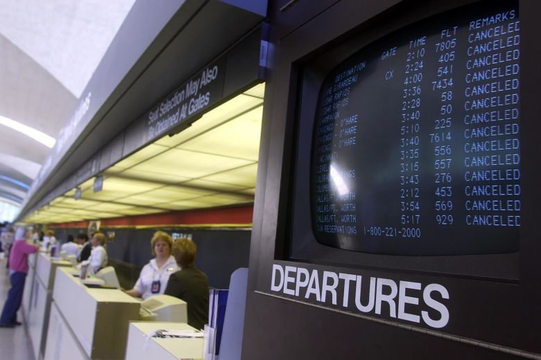 Monitors at Lambert-St. Louis International Airport indicate all flights have been cancelled.